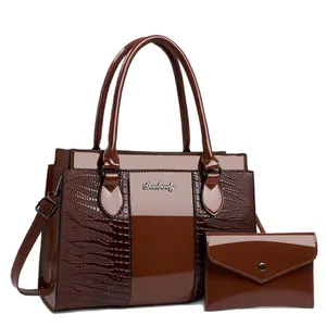 Three-piece dark brown crocodile embossed tote bag set with matching clutch and handle