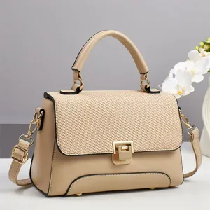 Fashionable beige macaron handbag with fabric patchwork flap and gold hardware