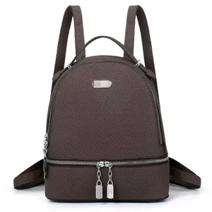 Quilted charcoal gray travel backpack with large capacity and silver metal zipper detailing
