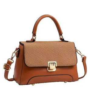 Brown macaron stylish handbag with woven flap and adjustable strap on white background