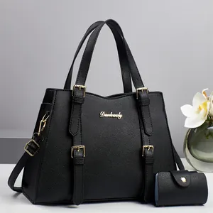 Classic black pebble leather tote bag with gold hardware and matching mini wallet