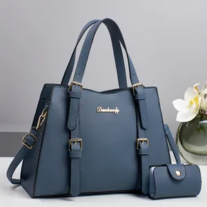 Classic navy blue textured tote bag with top handles and matching mini wallet set
