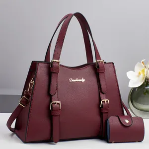 Detail of burgundy lychee grain leather handbag set with tote and small coin purse