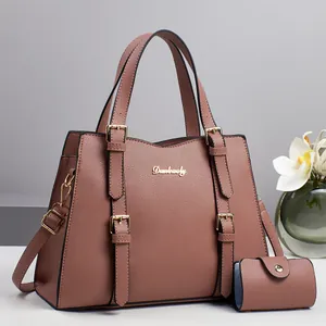 Dusty pink pebble leather tote bag set with matching small pouch and gold hardware details