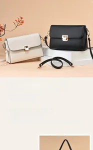 Détail de sacs bandoulière en cuir grainé noir et beige avec fermoirs métalliques dorés