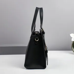 Side view of black lychee grain handbag featuring gold D-ring and zipper detail