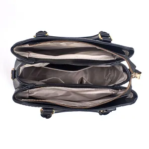 Top view of black leather handbag interior showing multiple storage compartments and zip pockets