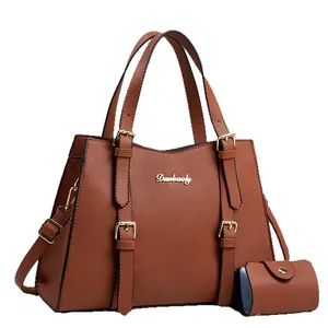 Brown litchi grain leather tote bag with gold hardware and small hanging purse