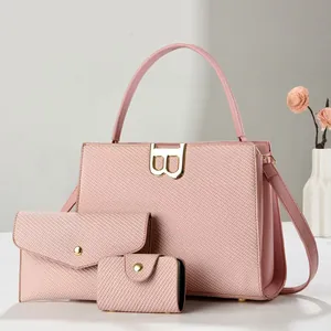 Detailed view of 3-piece pink tote set with textured embossing and gold B-buckle hardware