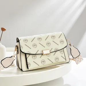 Women's cream printed crossbody bag with wide stripe strap and gold hardware