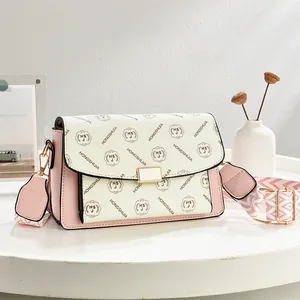 Chic monogram print shoulder bag in cream and pink with geometric wide woven strap
