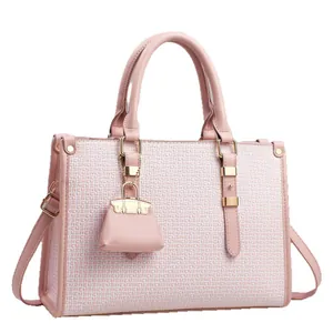 Pink and white textured leather tote bag with a matching mini pouch and gold hardware