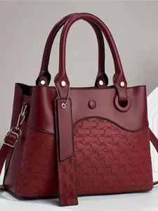 Elegant wine red PU leather handbag with woven texture and adjustable shoulder strap