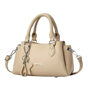 Elegant beige pebbled leather handbag for women with fashion text and star charm