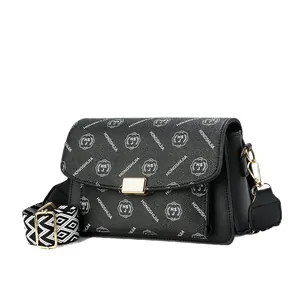 Black lychee texture crossbody bag with patterned strap and gold buckle closure