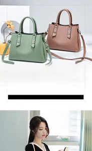 Detail of elegant two-tone handbags featuring textured leather and polished metal hardware