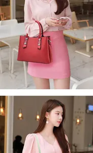 Detail view of a bright red leather tote with decorative silver chains in a cafe setting