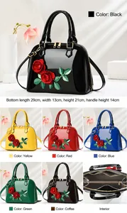 Detailed view of glossy patent handbag with floral accents and internal compartments
