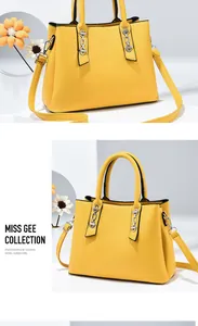 Detail of yellow trapezoid handbag featuring silver chain accents and fine stitching