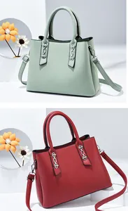 Detailed view of structured leather handbags in green and red with silver chain hardware