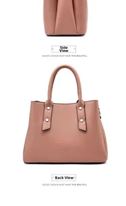 Detail view of pink crossbody bag showing side profile and back with rivet accents