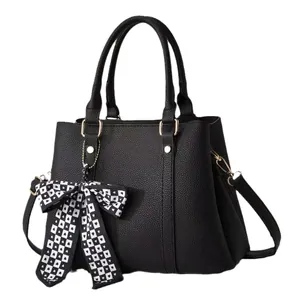 Elegant black lychee grain handbag with gold hardware and checkered heart scarf detail