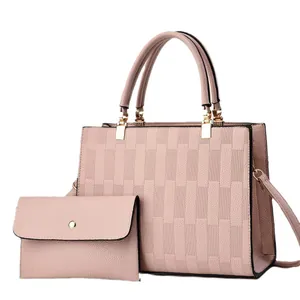Pink embossed tote bag set with matching clutch and golden metal accents
