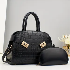 Large black crocodile embossed tote bag set with golden hardware and matching small pouch