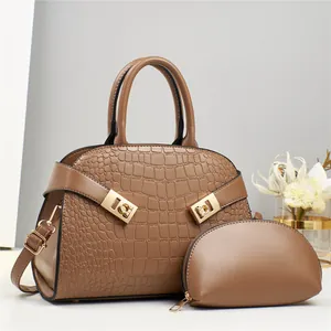 Detailed view of brown embossed tote bag with matching coin purse and golden hardware