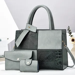 Detailed view of the three-piece handbag set featuring crocodile pattern and matte panels
