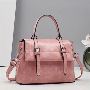 Macro shot of pink marble texture faux leather with silver buckle detail on handbag