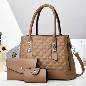 Detailed view of the tan quilted 3-in-1 handbag set featuring silver hardware accents
