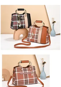 Detail of plaid tote bags with metal handles and decorative tassel pendants in two colors
