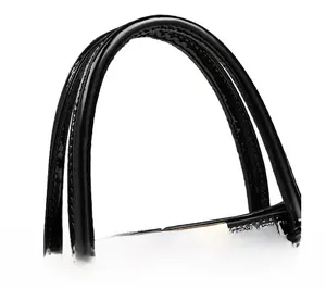 Detail of glossy black faux leather tote handle with golden metal accents and stitching
