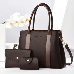 Detailed set of brown pebble leather tote, envelope wallet, and key pouch on white stand