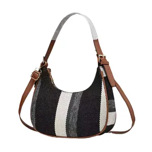 Hobo shoulder bag featuring vertical tri-color stripes and brown faux leather trim