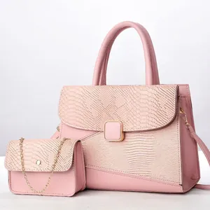 Detalle de bolso tote rosa con piel de serpiente y bolso de cadena con herrajes dorados