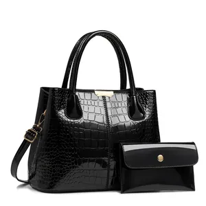 Women's black crocodile texture patent leather handbag set with gold metal details