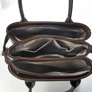 Interior detail of two-tone tote bag with organized compartments and fabric lining