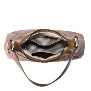 Detail view of the crescent shoulder bag showing interior lining and leather trim