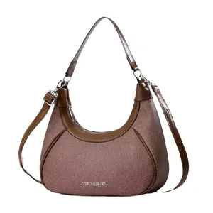 Chic crescent-shaped underarm bag in brown leather and canvas with adjustable strap