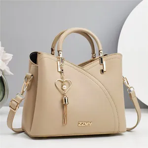 Elegant beige leather handbag with heart pearl charm and detachable shoulder strap