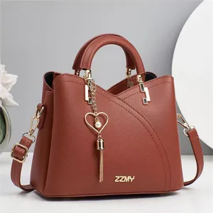 Brick red lychee leather handbag with ZZMY logo, metal chain and pearl heart pendant