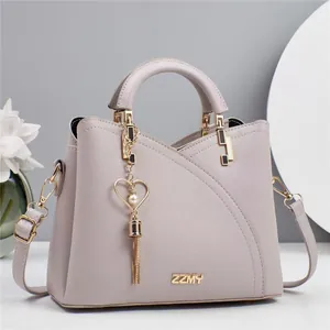 Detail of lavender litchi leather handbag with heart pendant and gold ZZMY branding