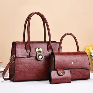 Ensemble trois pièces de cabas bordeaux avec cadenas doré et texture raffinée