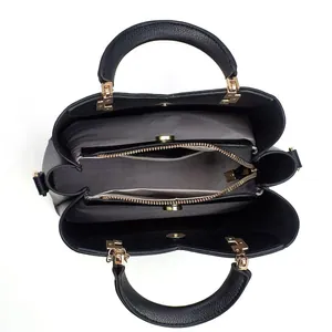 Top-down view of black tote bag interior with multiple compartments and gold zipper