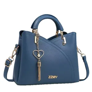 Blue lychee leather tote bag with gold hardware and a heart tassel pearl charm