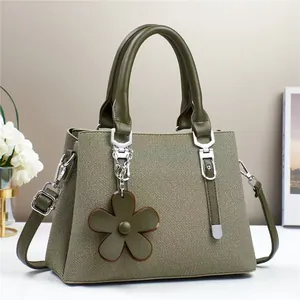 Sac à main femme vert foncé en tissu tissé avec garniture en cuir et pendentif fleur