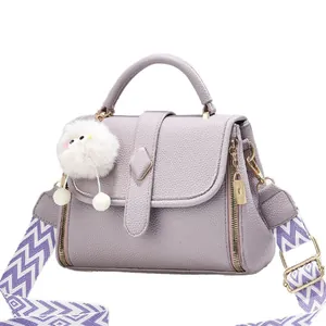Sac à main violet en similicuir avec bandoulière géométrique et pompon blanc doux