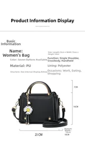 Detail view of black PU handbag with daisy pendant showing 23x10x16cm dimensions